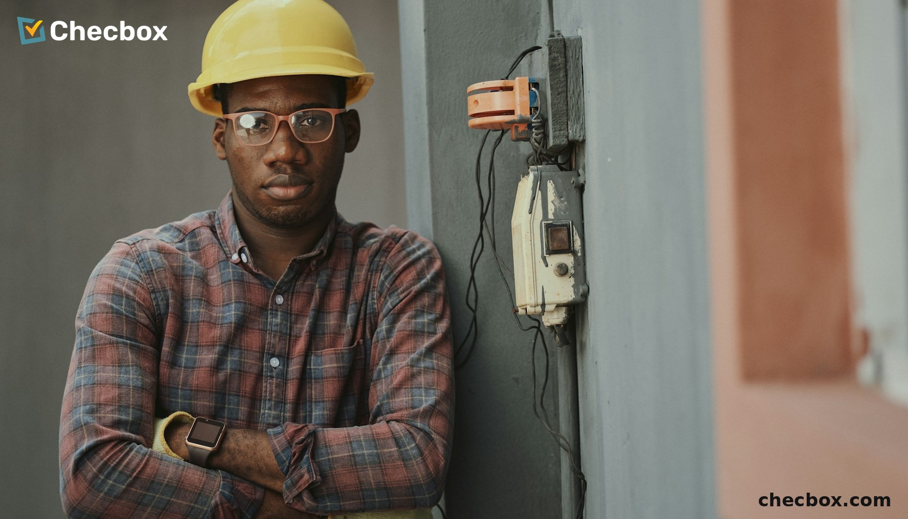 Electrician working on electrical wiring with mobile app